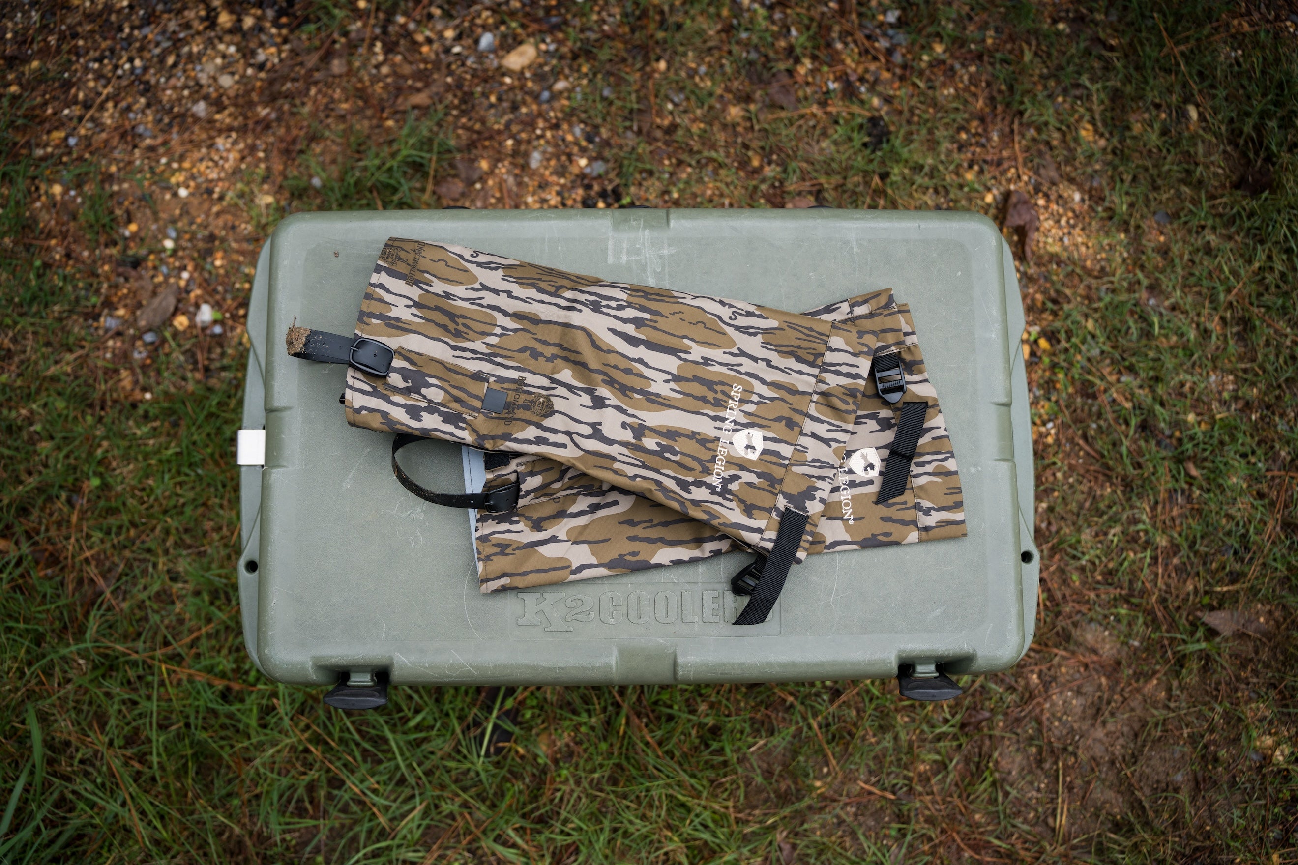 Camouflage hunting pants on a green cooler outdoors